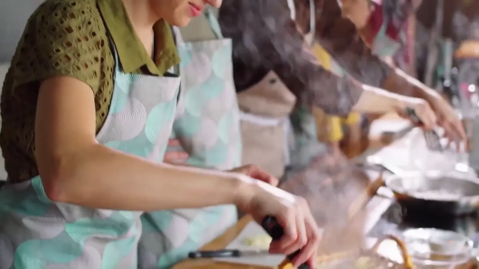 Hands cooking in the kitchen at Elaios.